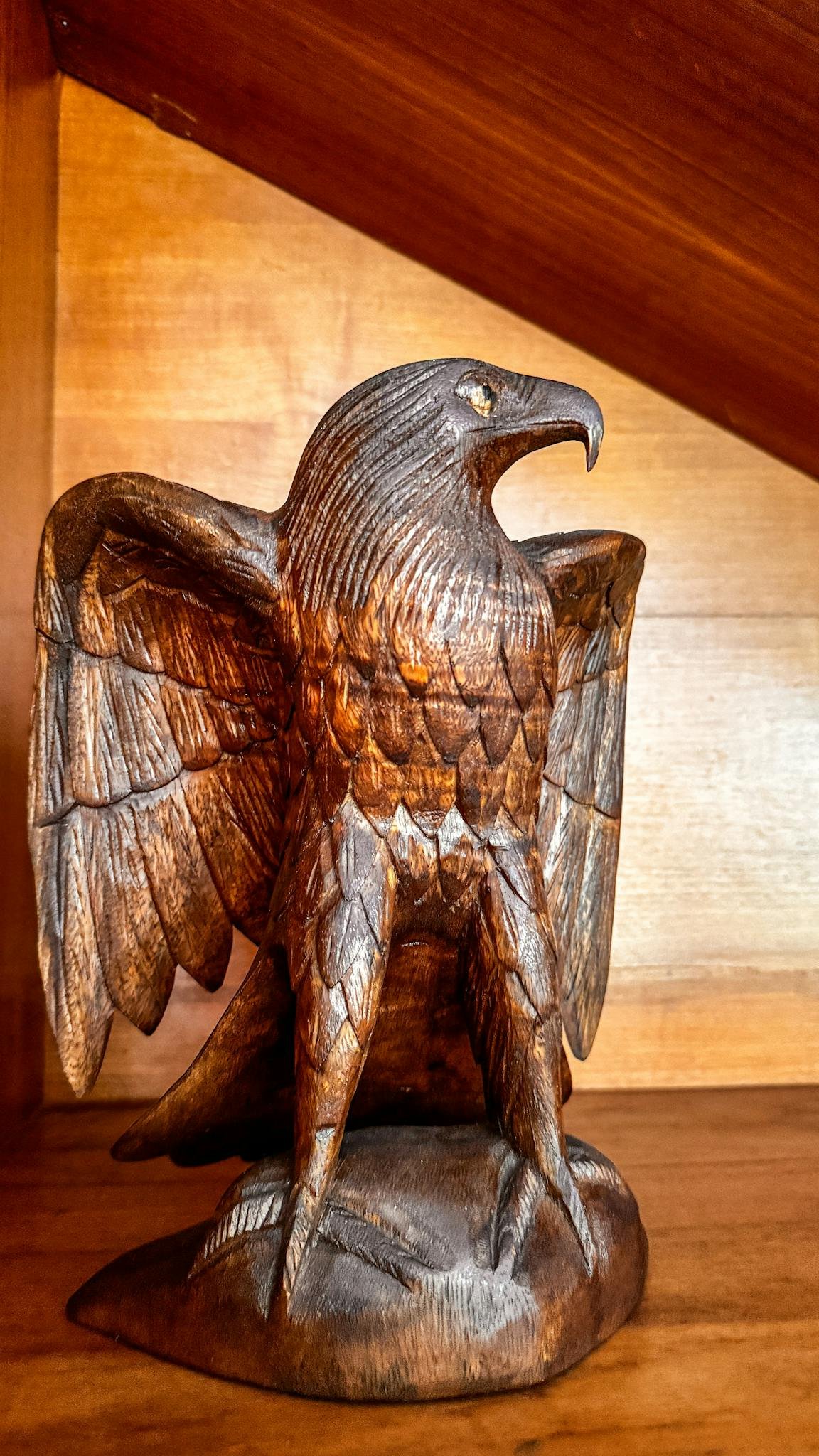Detailed hand-carved wooden eagle sculpture in Bali, Indonesia showcasing exquisite craftsmanship.